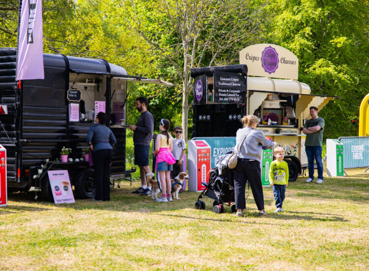 Gourmet food trucks and families at the sunny Malahide Food Market on the Casino Museum grounds.