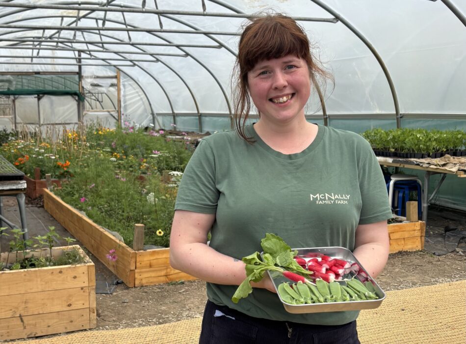 McNally's farm employee holding a serving tray of vegetables