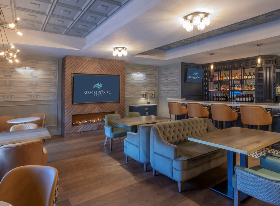 Stylish lounge and bar at the Bracken Court Hotel, featuring comfortable seating, contemporary lighting, a fireplace and a well-stocked bar.
