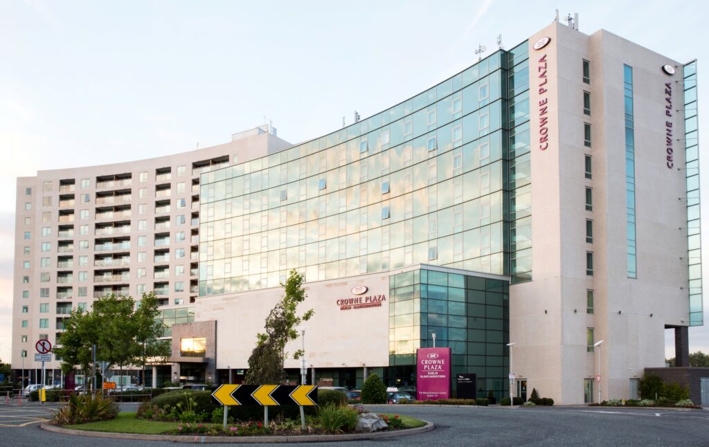 External view of the modern Crowne Plaza hotel building in Blanchardstown with its signature glass facade.