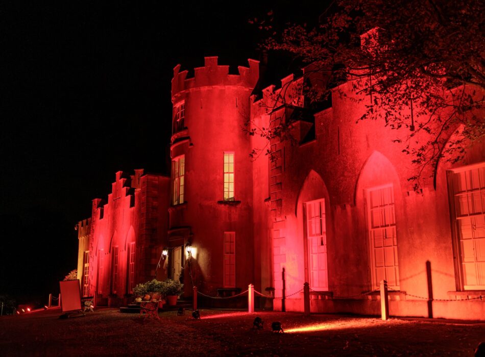 Ardgillan Castle lit up with red light at night